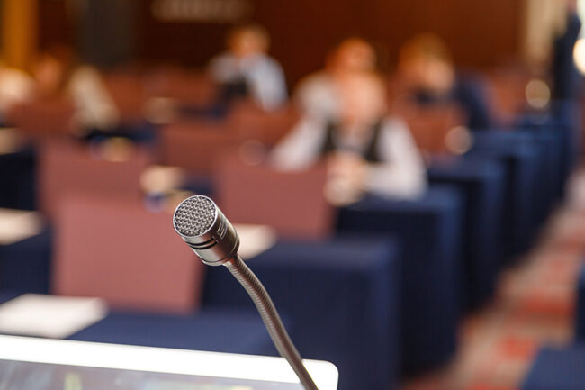 Microphone over conference hall background, Business meeting concept